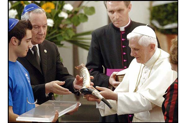 Benedict receiving a shofar horn from a rabbi